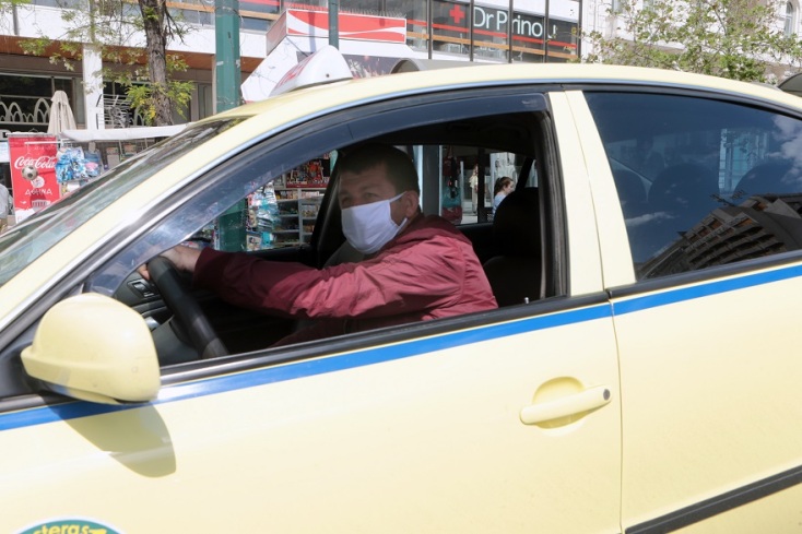 Οδηγός ταξί με προστατευτική μάσκα