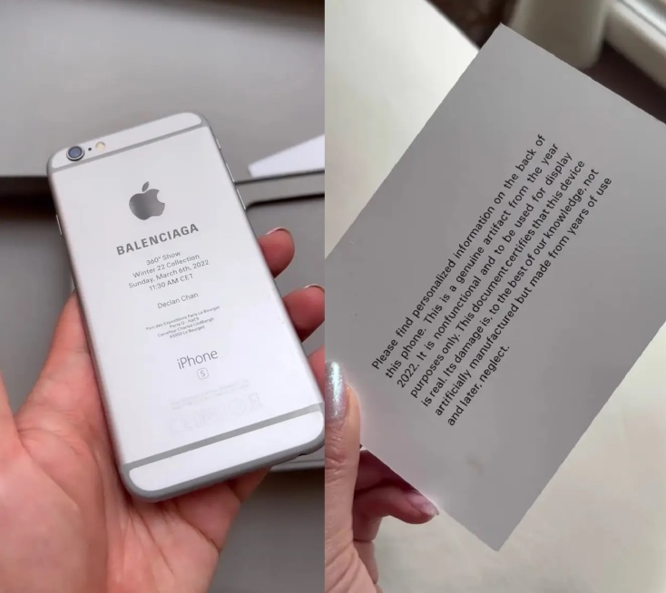 Σπασμένο κινητό iPhone 6S και χαρτί πρόσκληση για το fashion show Balenciaga