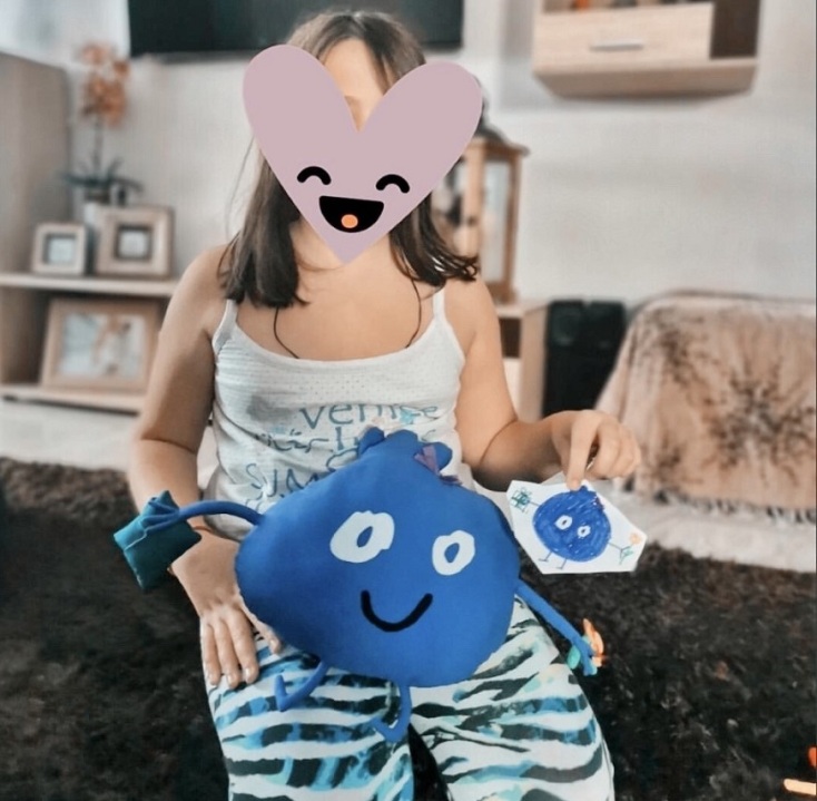 Παιδάκι κρατάει ζωγραφιά και κουκλάκι