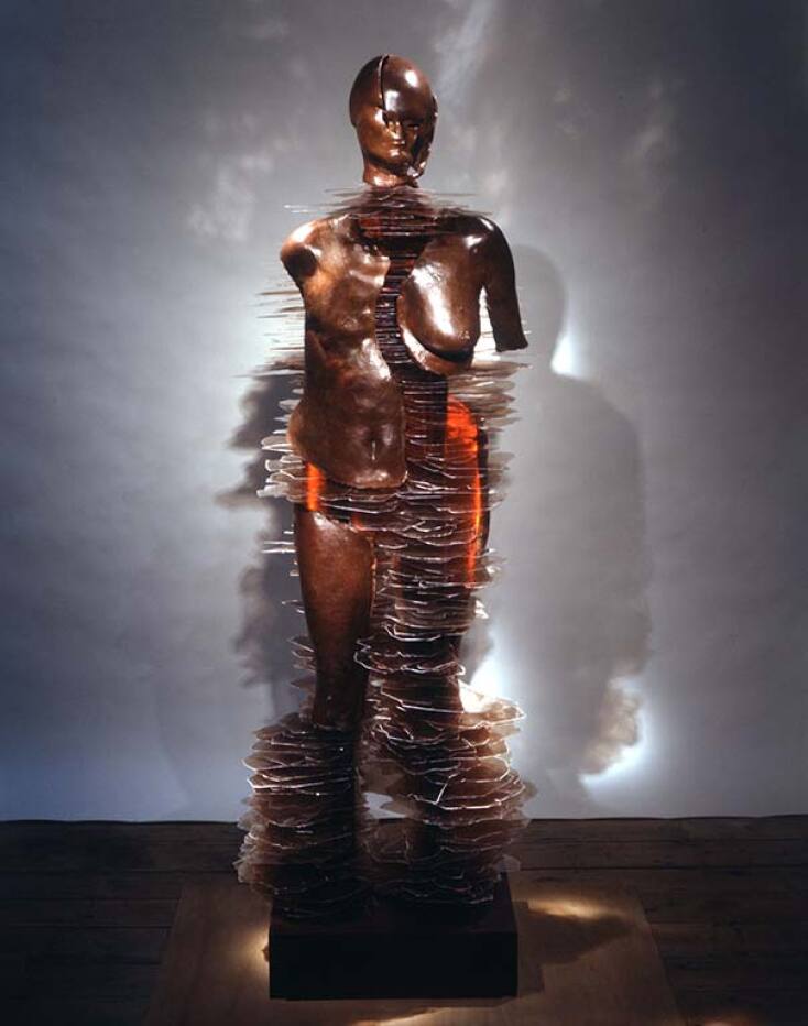 Liliane Lijn, Fire My Soul- 2000, Patinated bronze, ruby mica, neon, brass and stainless steel fittings. Full-size self-portrait.