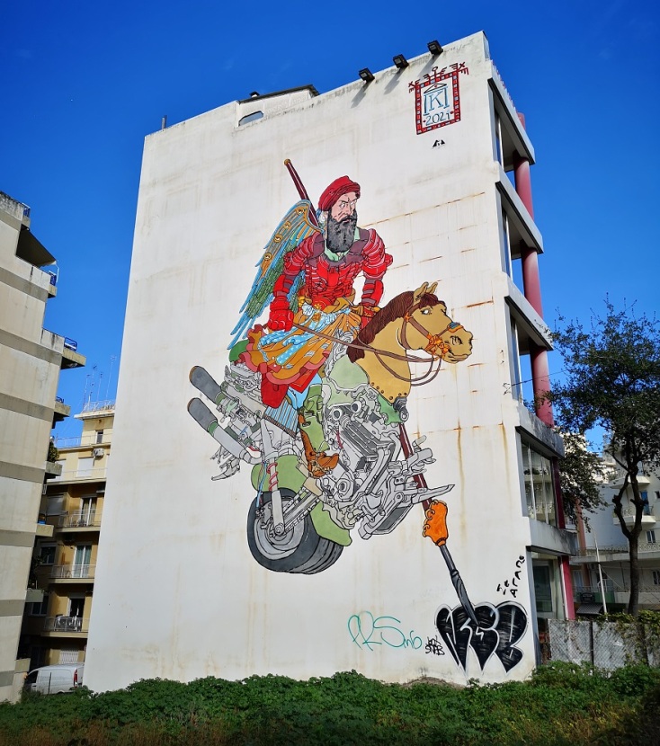 Mural του Κωνσταντίνου Παπαμιχαλόπουλου στην Πάτρα. Mural του Κωνσταντίνου Παπαμιχαλόπουλου στην Πάτρα.