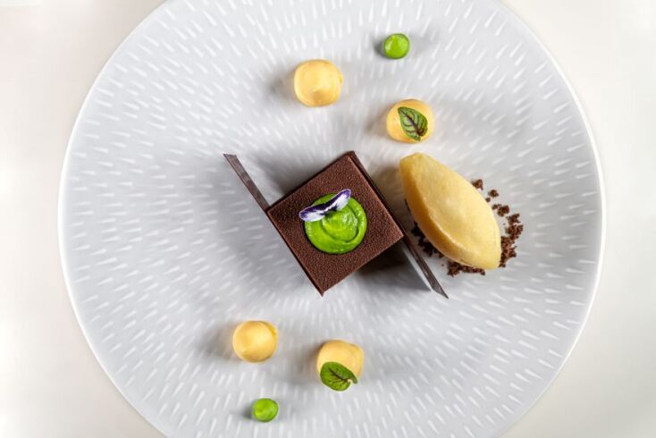 Crémeux σοκολάτας, ganache καραμέλα, πραλίνα φυστίκι, πουρέ αρακά, sorbet πορτοκάλι - βασιλικό.