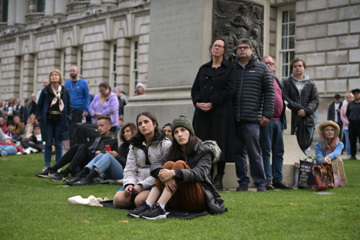 Πολίτες, σιωπηλοί και δακρυσμένοι παρακολουθούν από γιγαντοοθόνη σε πάρκο την κηδεία της βασίλισσας Ελισάβετ