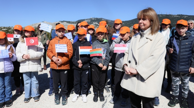 Η κ. Σακελλαροπούλου με μαθητές που κρατούν τις σημαίες χωρών των πρέσβεων
